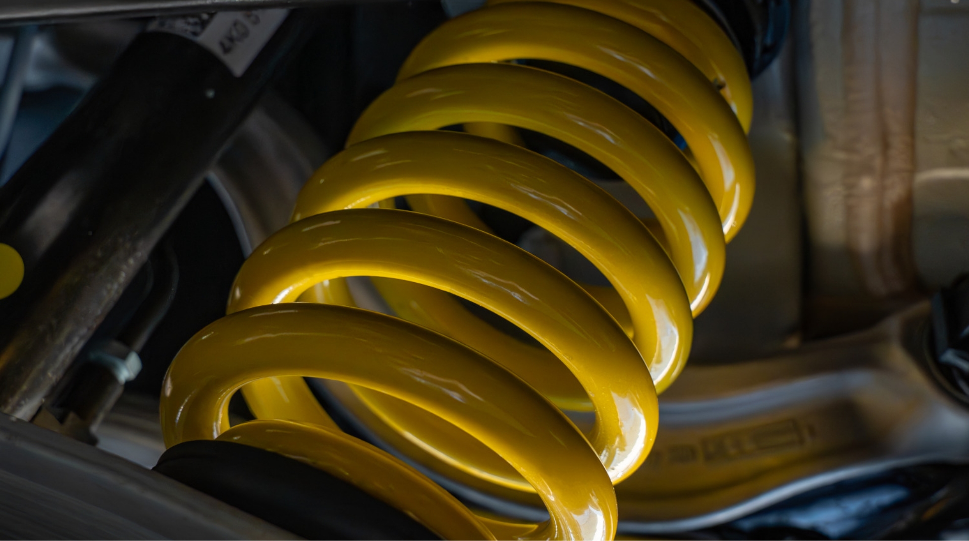 Close-up of yellow ABT sport suspension spring and damper